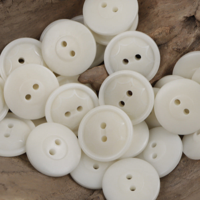 Natural white round two-hole octagram tagua nut buttons with embossed star pattern