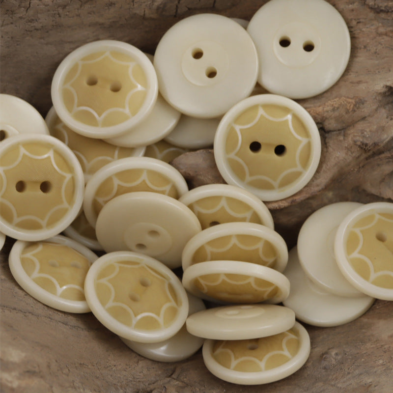 Natural yellow-cream round two-hole octagram tagua nut buttons with embossed star pattern