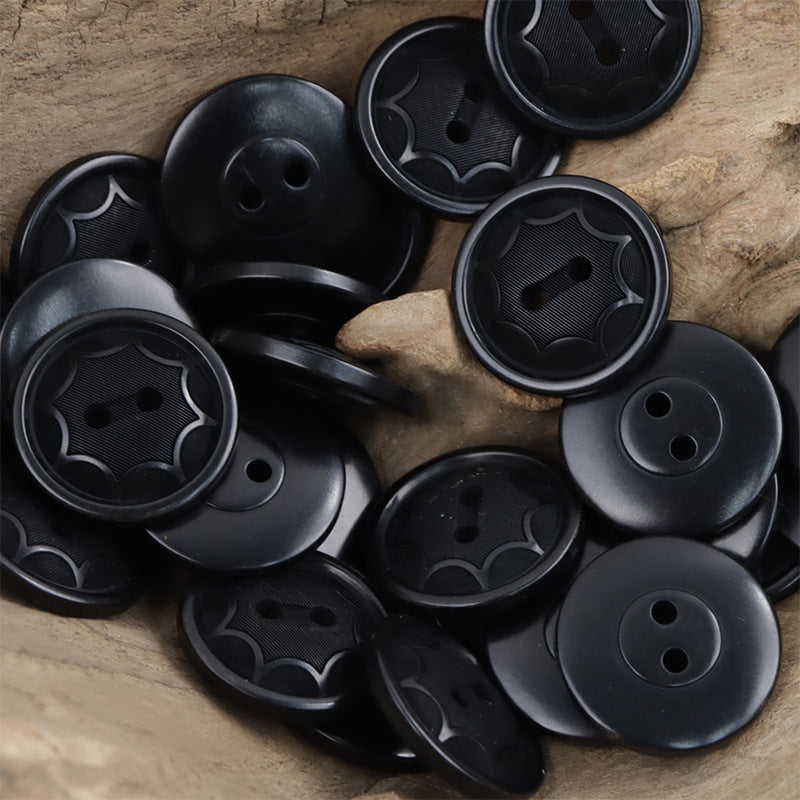 Black round two-hole octagram tagua nut buttons with embossed star pattern