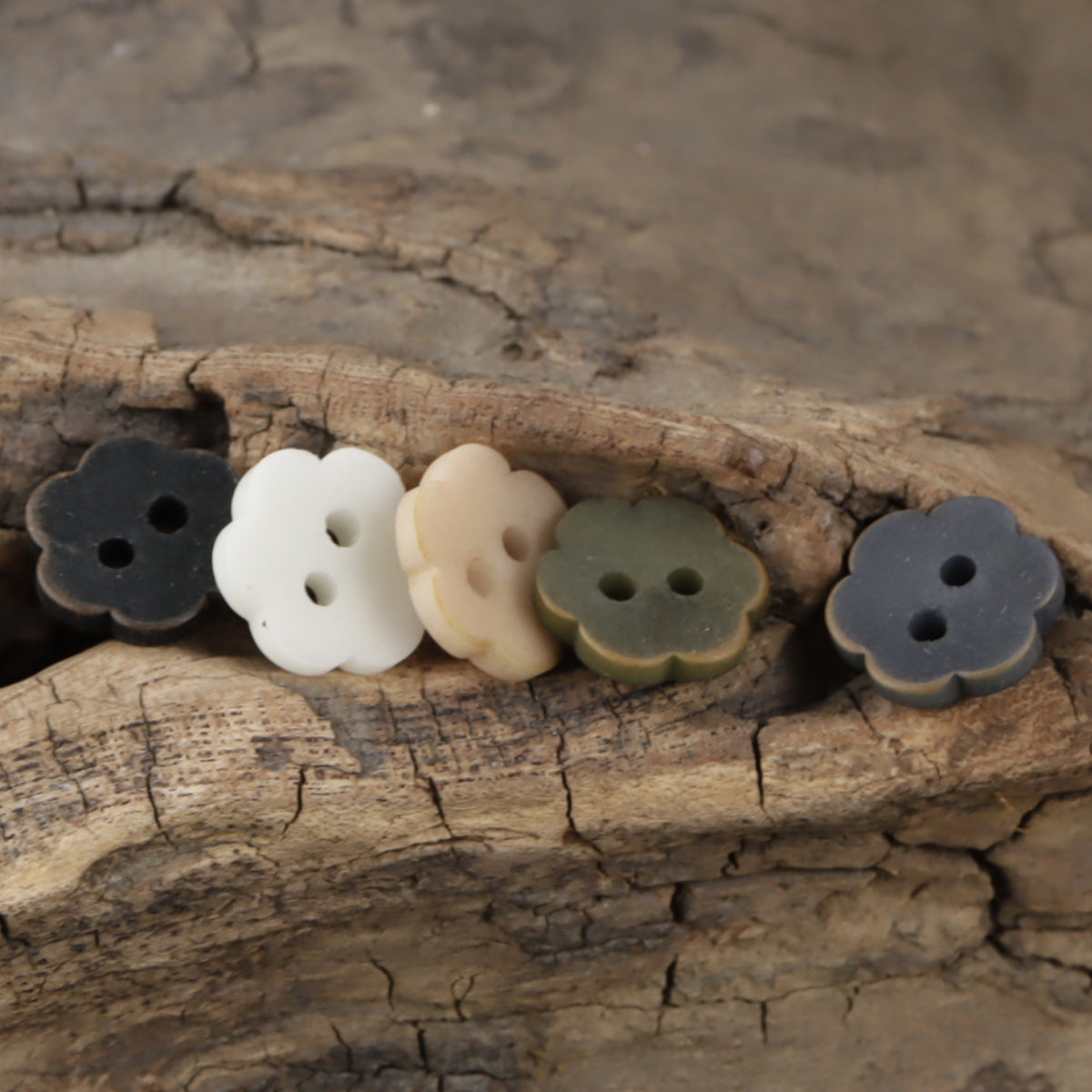 Floral tagua nut buttons in dark colors, light orange, white, and green, 2-hole