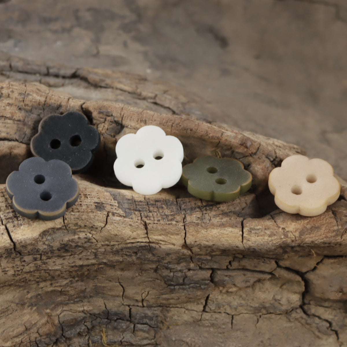 Floral tagua nut buttons in black, white, green, and light orange, 2-hole