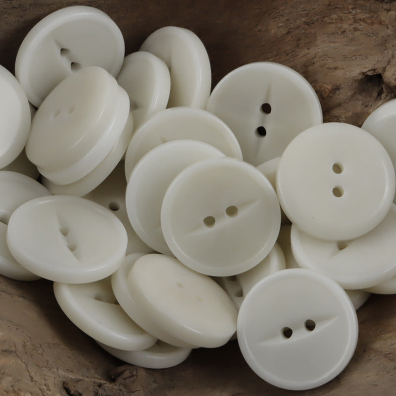 Round two-hole corozo buttons, white, multiple pieces