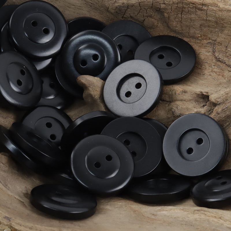 Classic two-hole nut buttons in black, round with 2 holes; 10 pcs