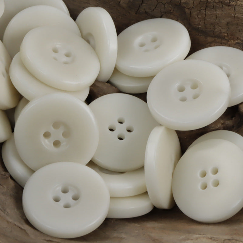 White wide border palm nut buttons, round four-hole fronts, mixed angles