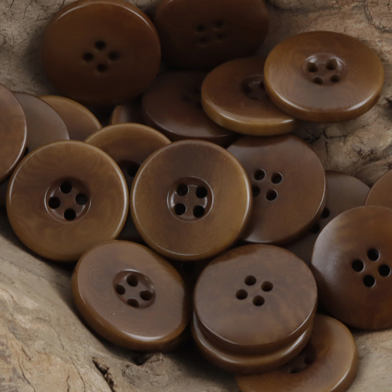 Coffee brown wide border palm nut buttons, round four-hole fronts, close-up