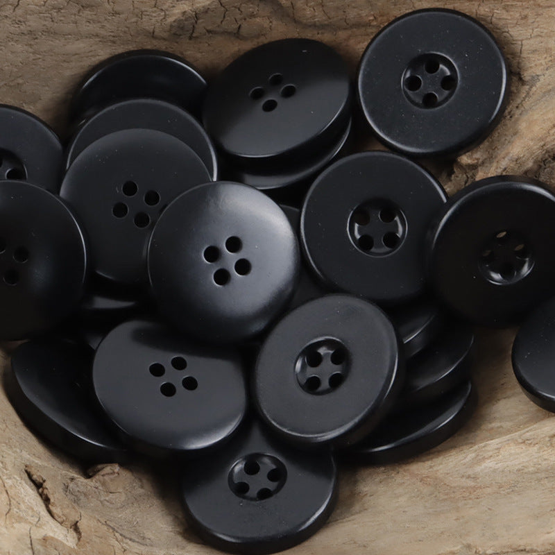 Black wide border palm nut buttons, round four-hole fronts, close-up