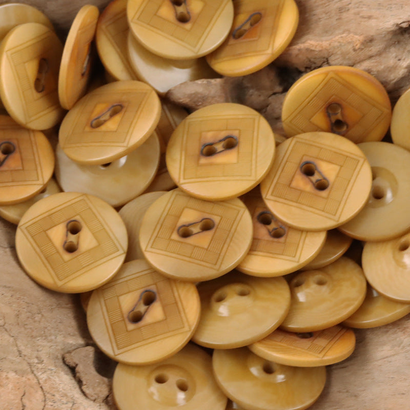 Beige/yellow chessboard-style tagua nut button with two holes