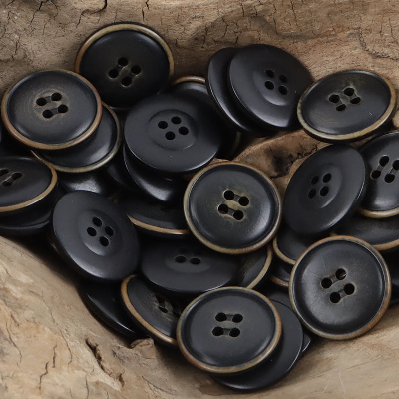 Dark gray fire-burned tagua nut buttons: bronze-rim round fronts with 4 holes