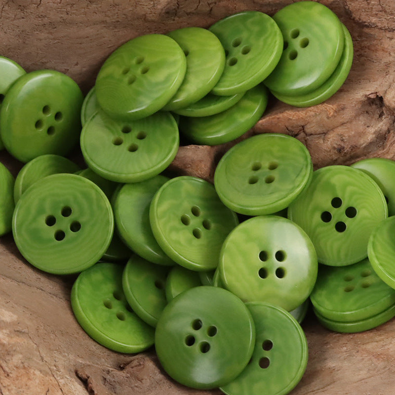 Round flat green four-hole nut buttons, assorted pieces in a bundle