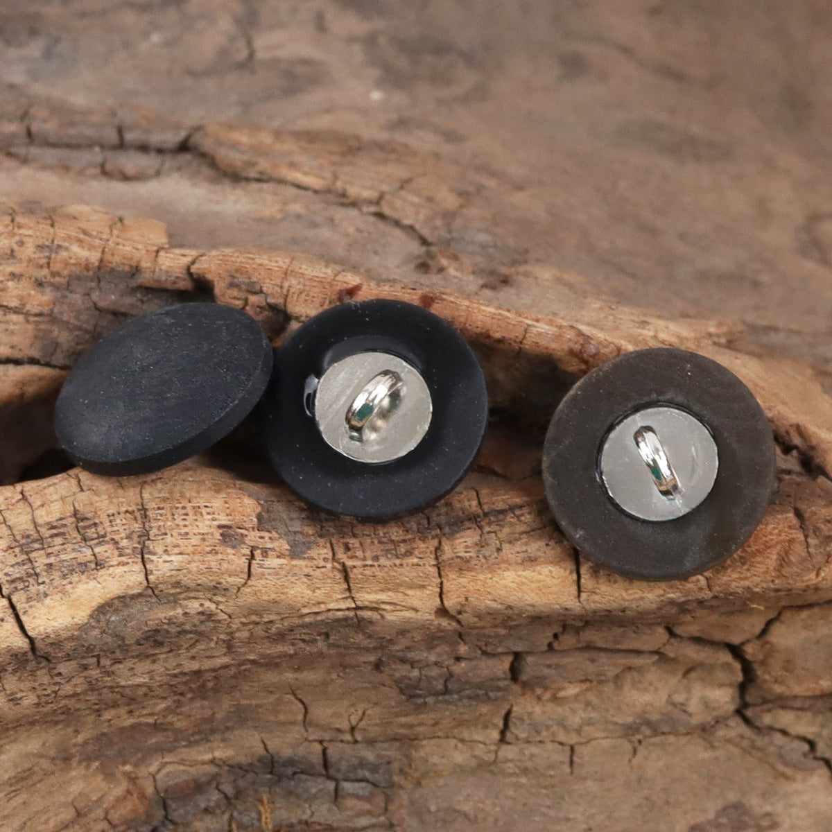 Matte black fruit buttons with metal stems and silver shank backs