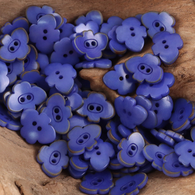 Blue-purple butterfly-shaped nut buttons with two-hole centers and stitched rim