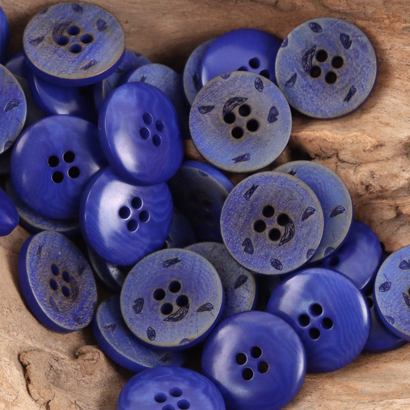 Blue round 4-hole nut buttons with dark leaf/flower etching