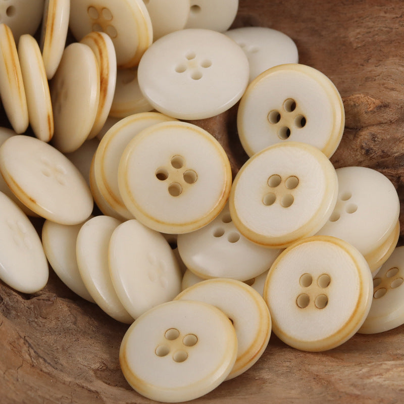 Bulk lot of cream palm fruit buttons with light caramel rim and 4-hole centers