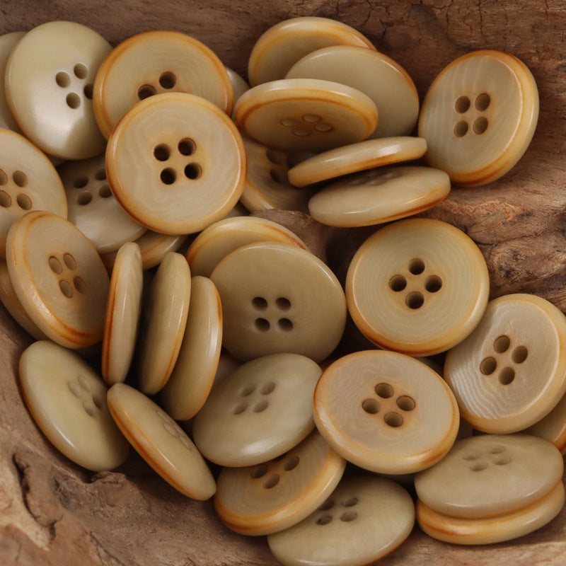 Palm fruit buttons lot in cream and caramel tones; round with 4-hole fronts and flame-edged rims