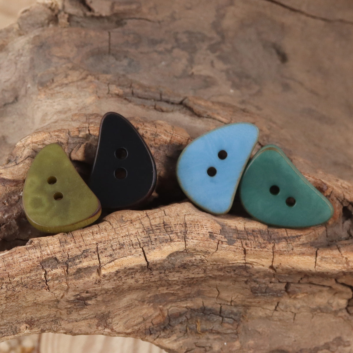 Crescent moon corozo buttons with two holes in black, olive, light blue, teal
