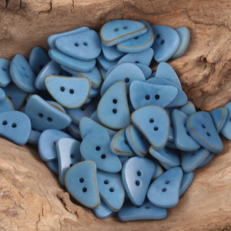 Light blue crescent moon corozo buttons with two holes, mixed shades