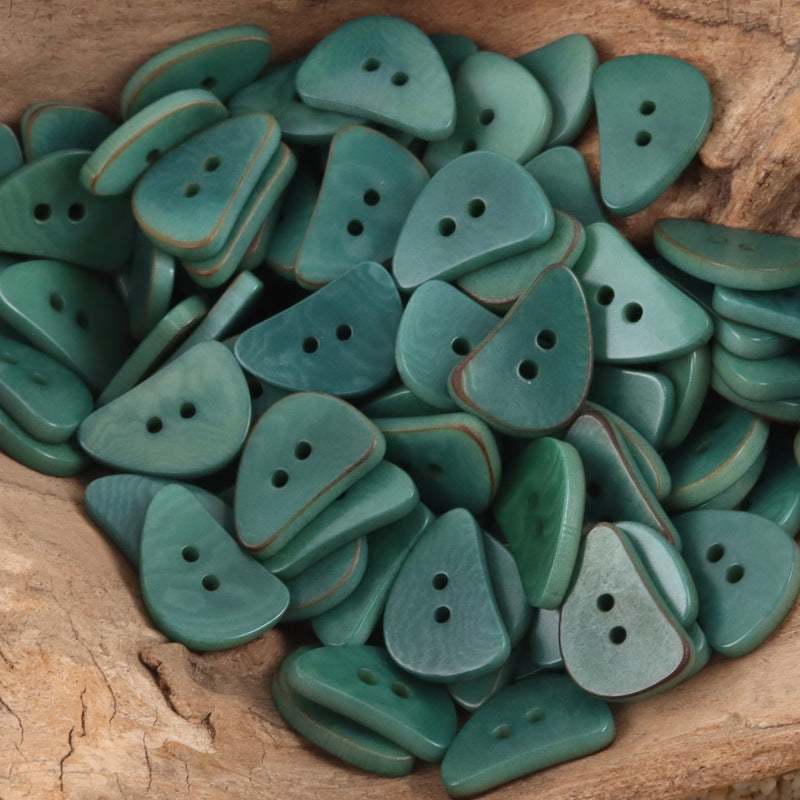 Teal crescent moon corozo buttons with two holes, assorted sizes