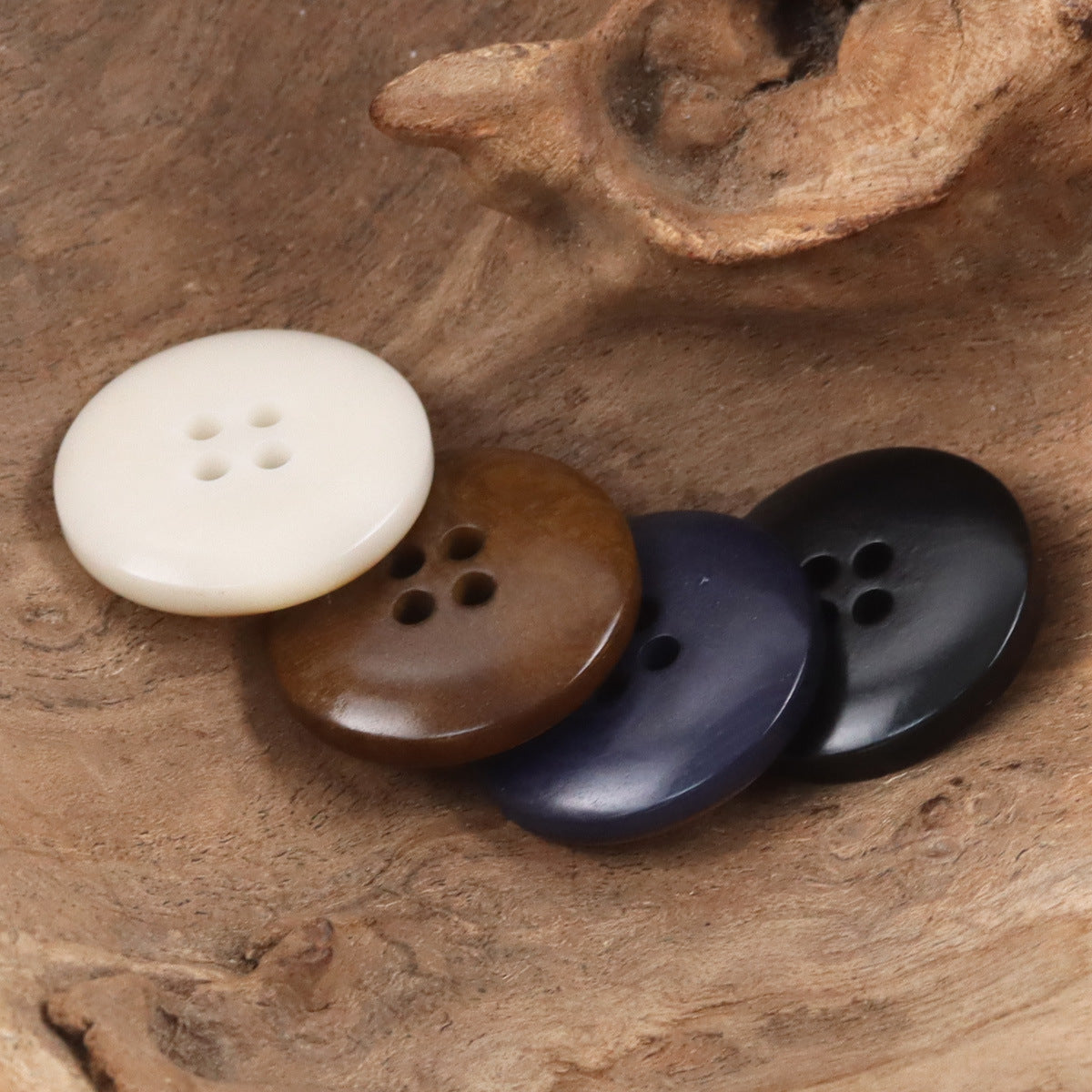 Nut-style buttons in beige, coffee brown, and dark blue/black, round with 4 holes