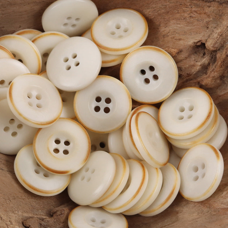 Assorted beige nut-style buttons, round with tan rim and 4-hole design