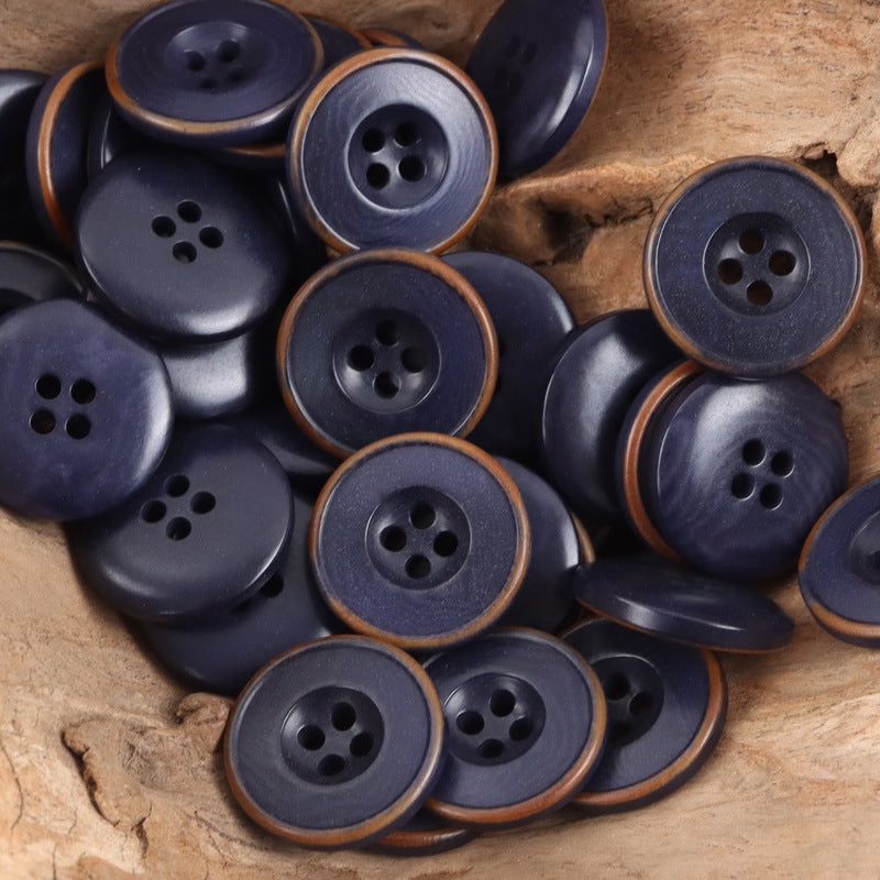 Deep blue nut-style buttons in a mixed pile, round with 4-hole faces
