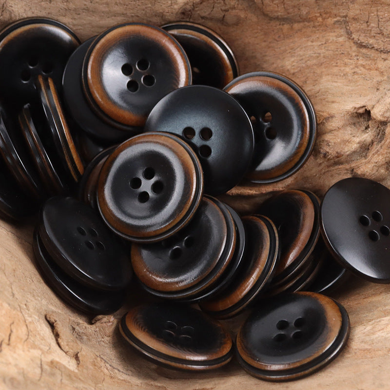 Assorted black and brown round coat buttons with four-hole faces