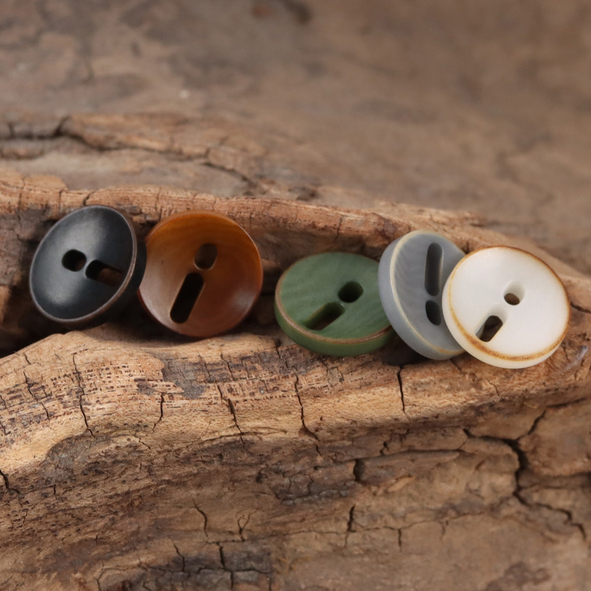 Palm fruit buttons with exclamation mark cutout in dark gray, coffee brown, green, and beige.