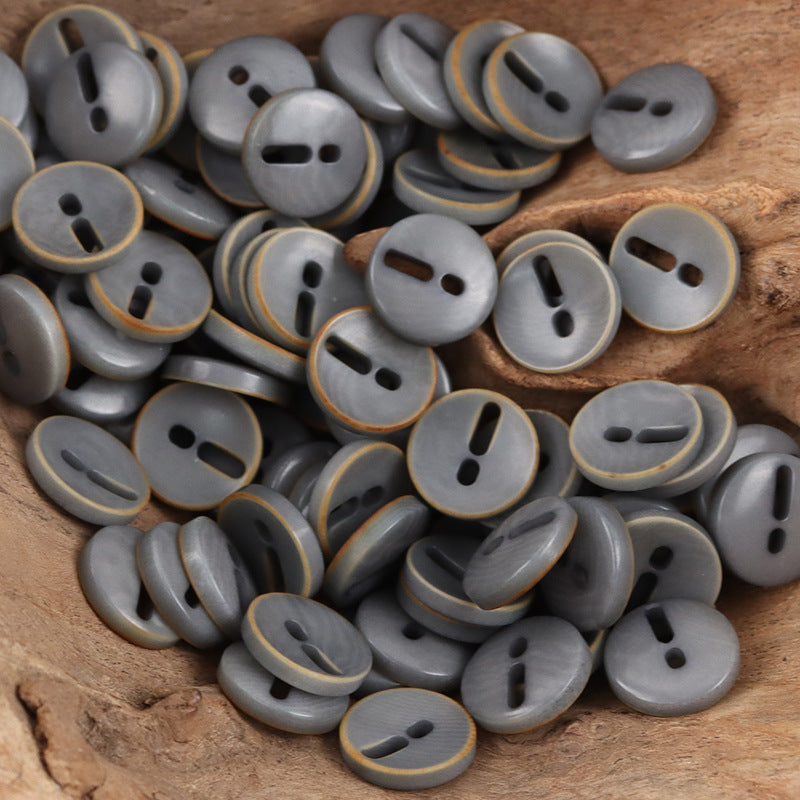 Gray palm fruit buttons with exclamation mark cutout, round, 2-hole style look.