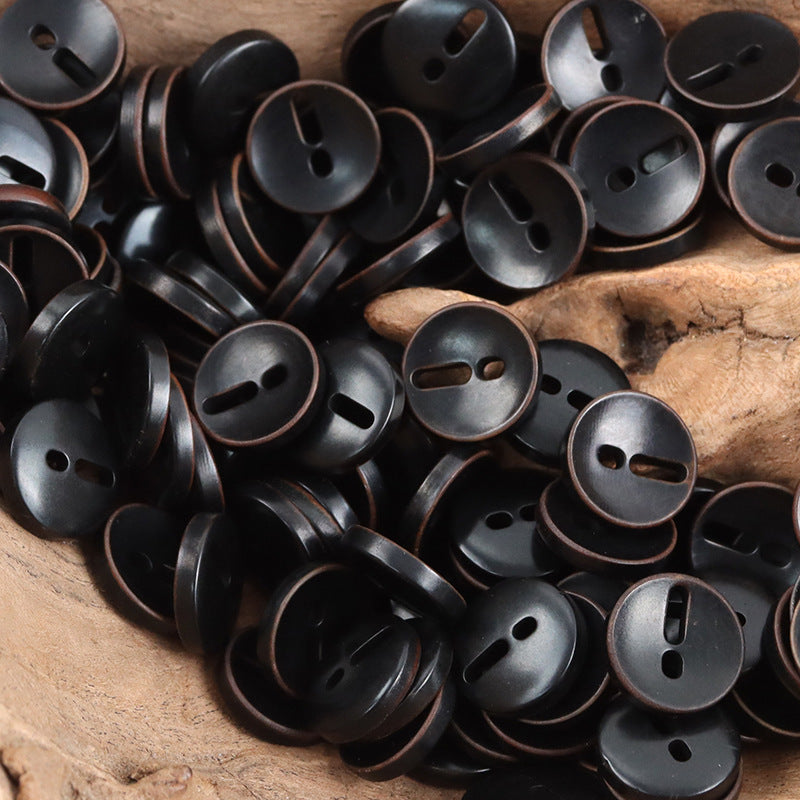 Dark gray/black palm fruit buttons with exclamation mark cutout, round, 2-hole style look.