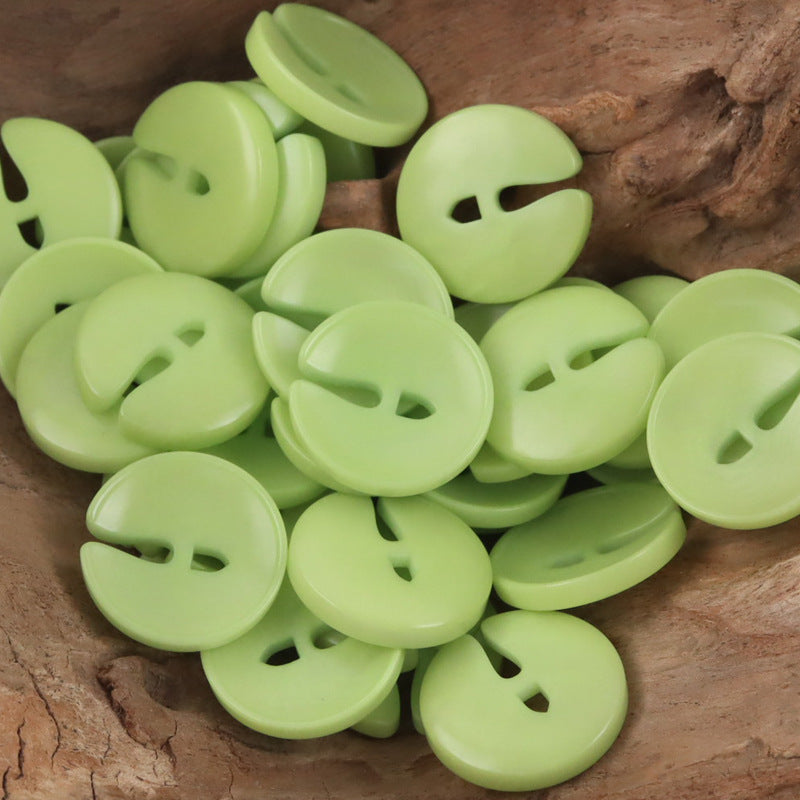 Pac-Man tagua nut buttons in bright green with face cutouts