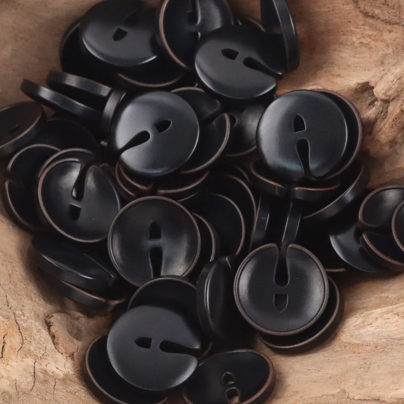 Pac-Man tagua nut buttons in dark black with face cutout eyes and mouth