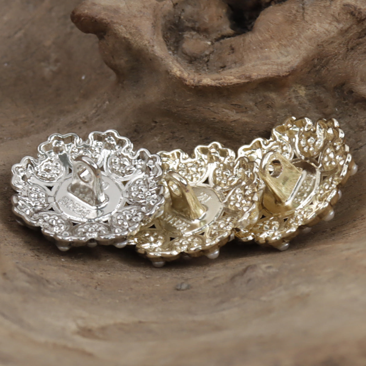 Gold and silver pearl metal buttons, ornate round setting with central pearl