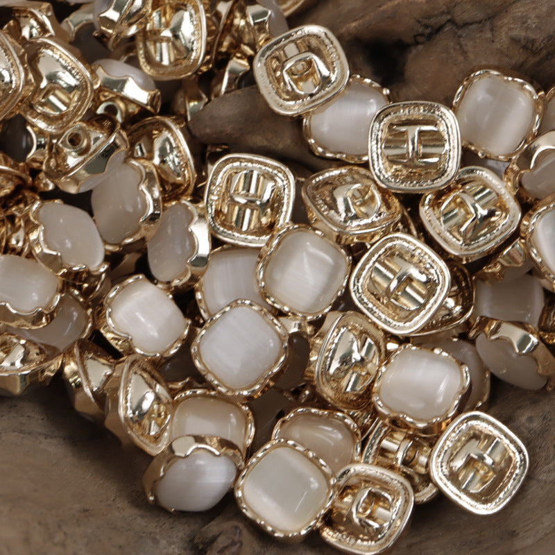 Cream/white square jade buttons with shiny silver metal edges and shank backs