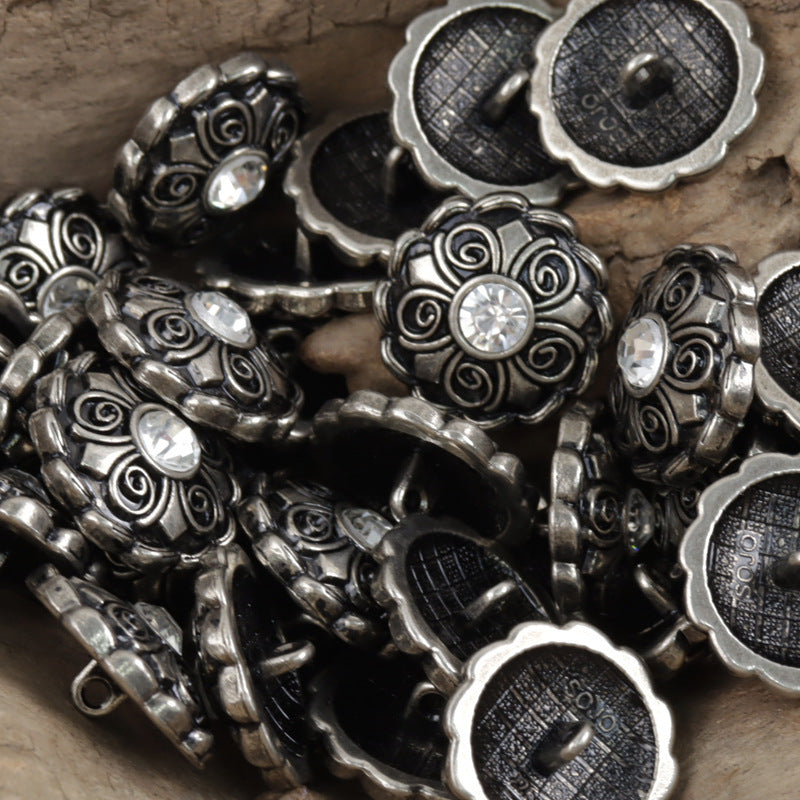 Antique coat buttons with clear crystal centers and dark filigree, metal assortment