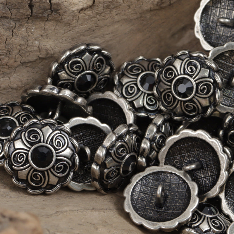 Antique coat buttons with black center stones, silver-tone filigree close-up assortment