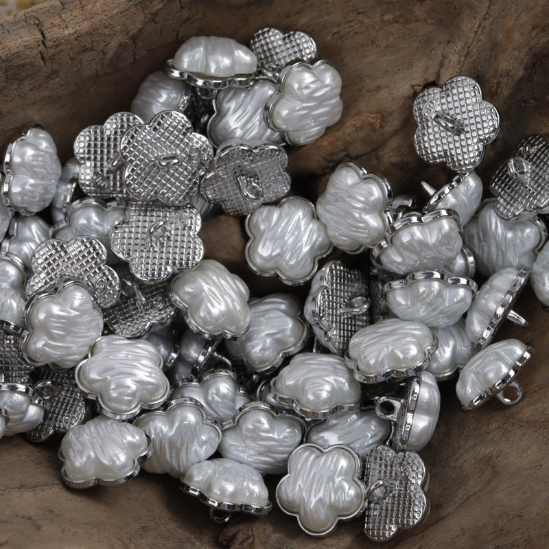 Lot of flower-shaped white resin metal buttons with silver backs and loop shanks