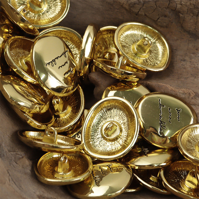 Shiny irregular oval metal button fronts, mostly gold with looping shank details