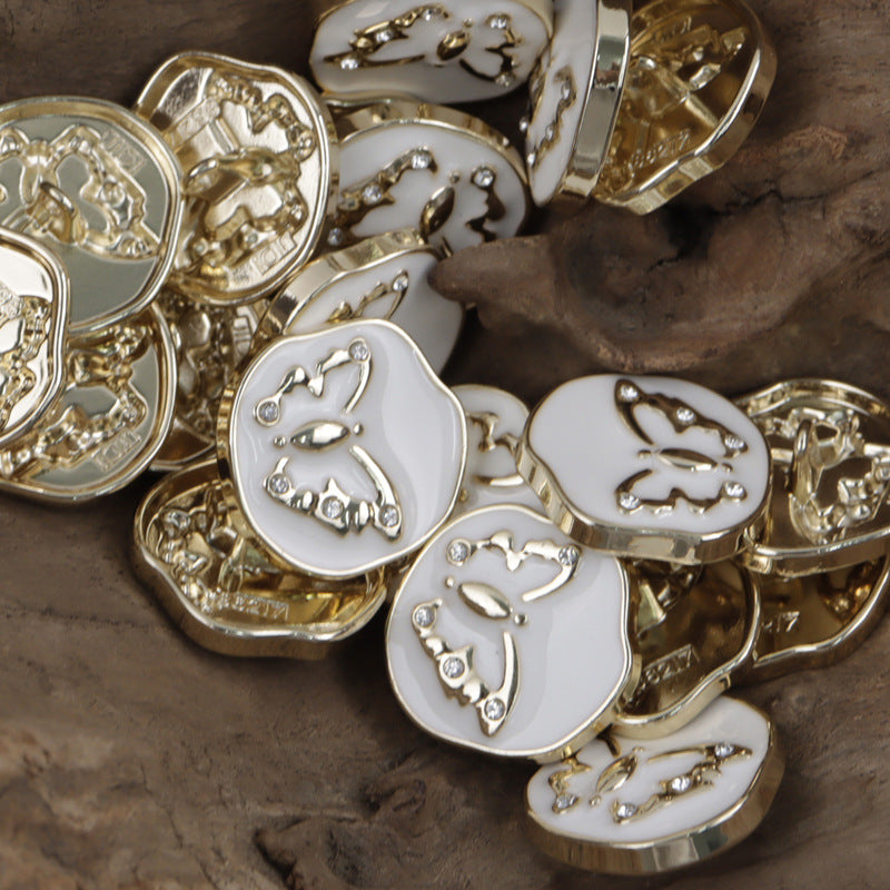 Assorted metal shank buttons with butterfly pattern, white enamel, gold-tone metal and studs