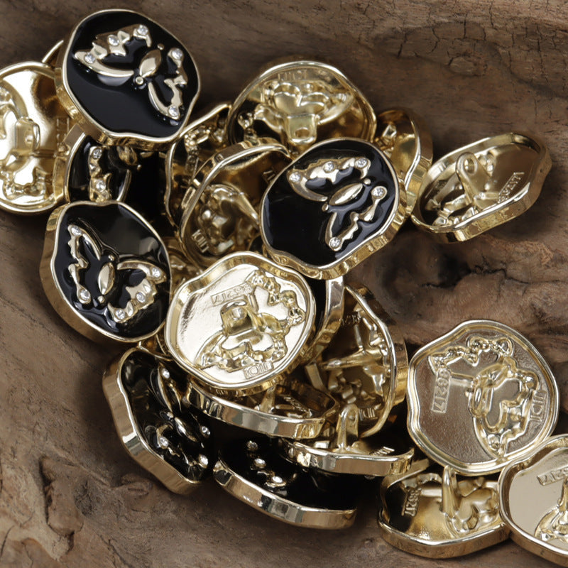 Mixed metal shank buttons with butterfly pattern: black and gold finishes, rhinestone details