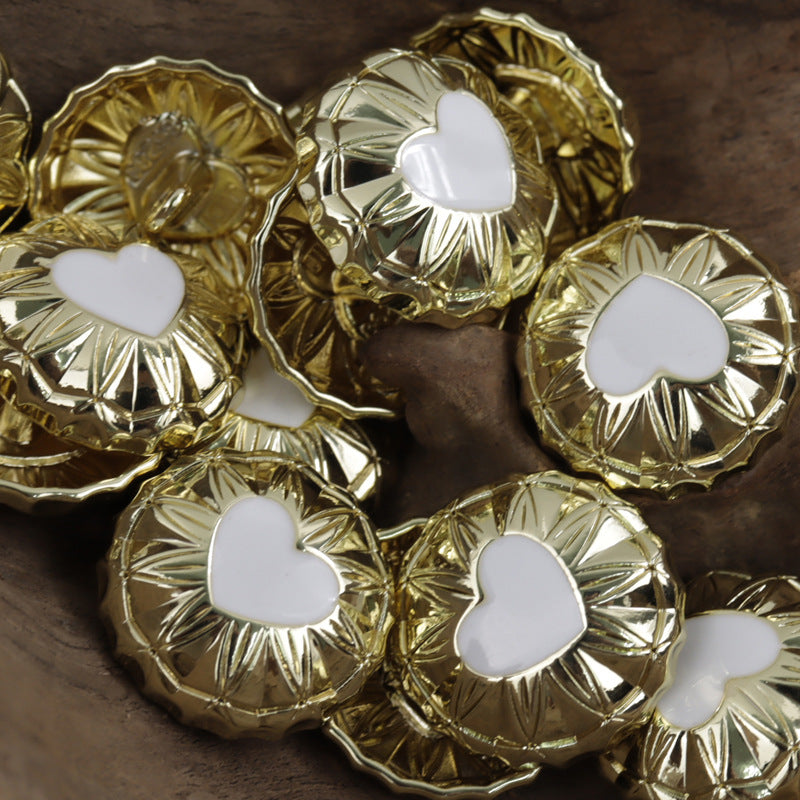 Round gold metal shank buttons with white heart inlay, ornate border