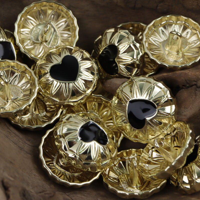 Round gold metal shank buttons with black heart inlay, ornate border