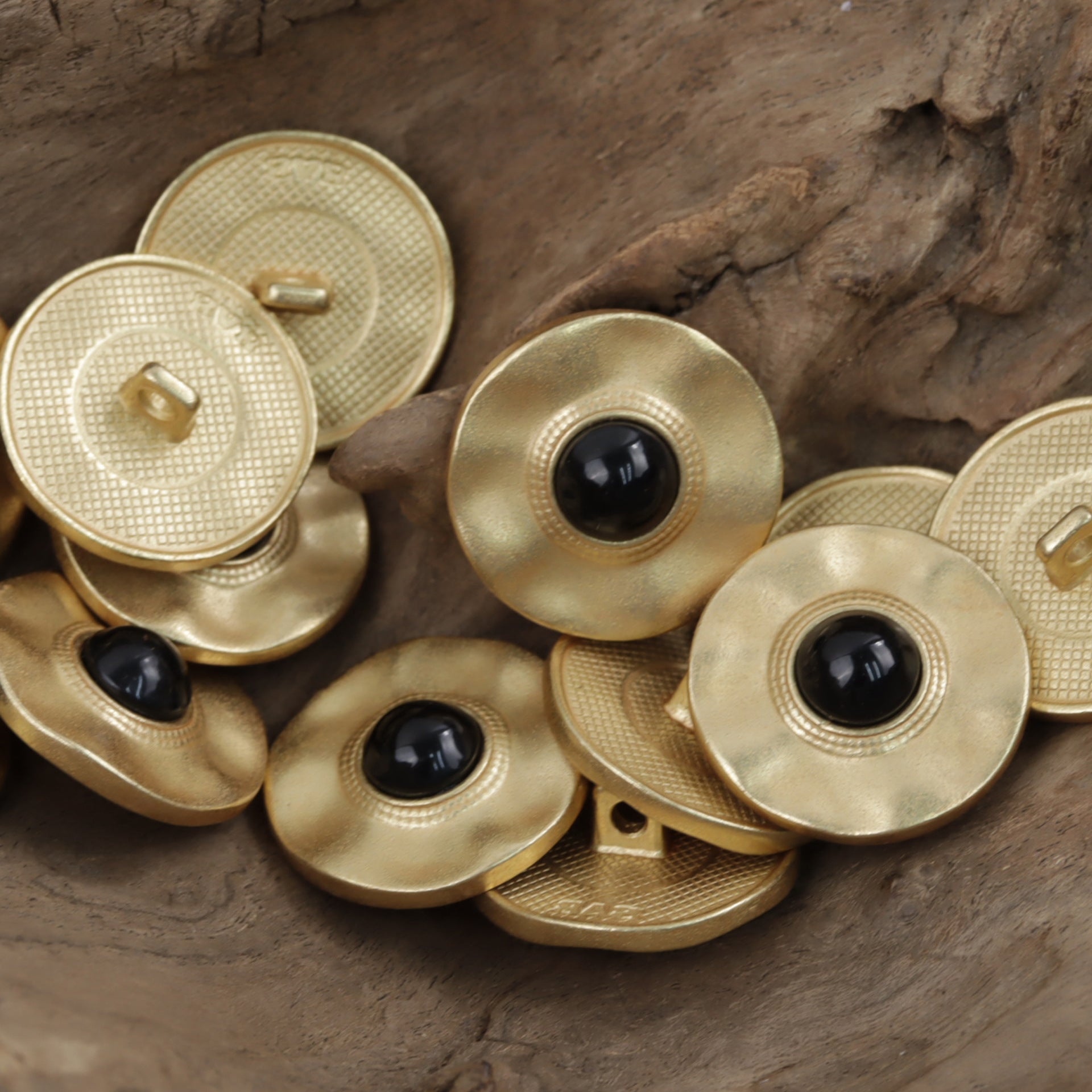 Gold metal coat buttons with black pearl inlay, multiple pieces arranged
