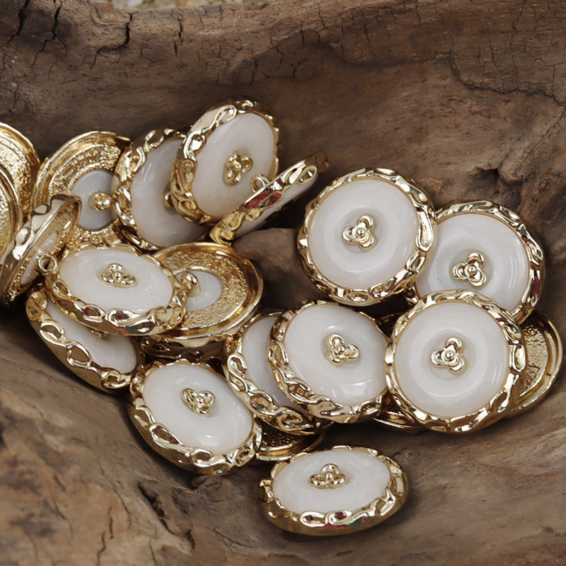 Gold resin-metal shamrock buttons with white centers and raised clover detail