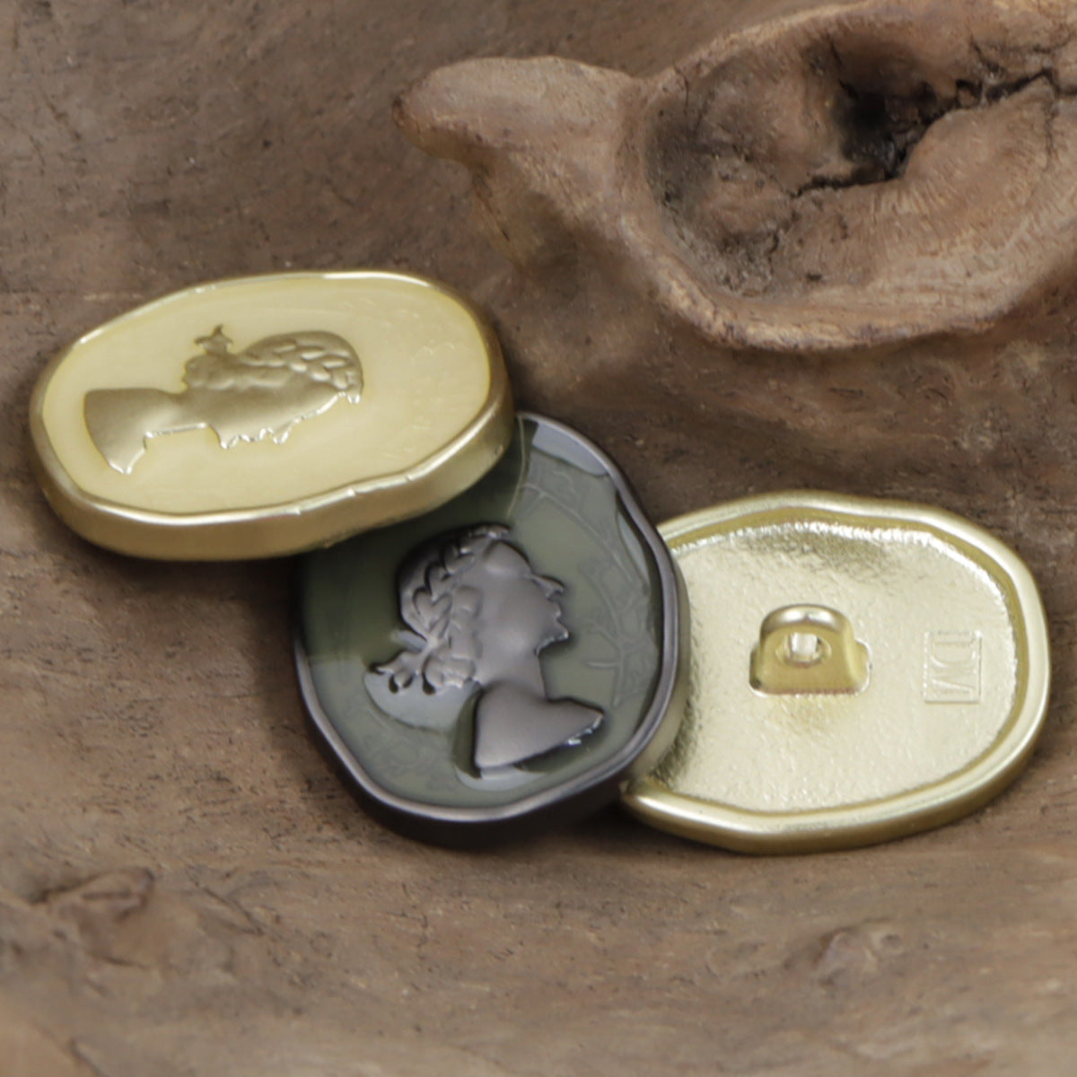 Gold metal decorative button with painted girl cameo relief and textured border