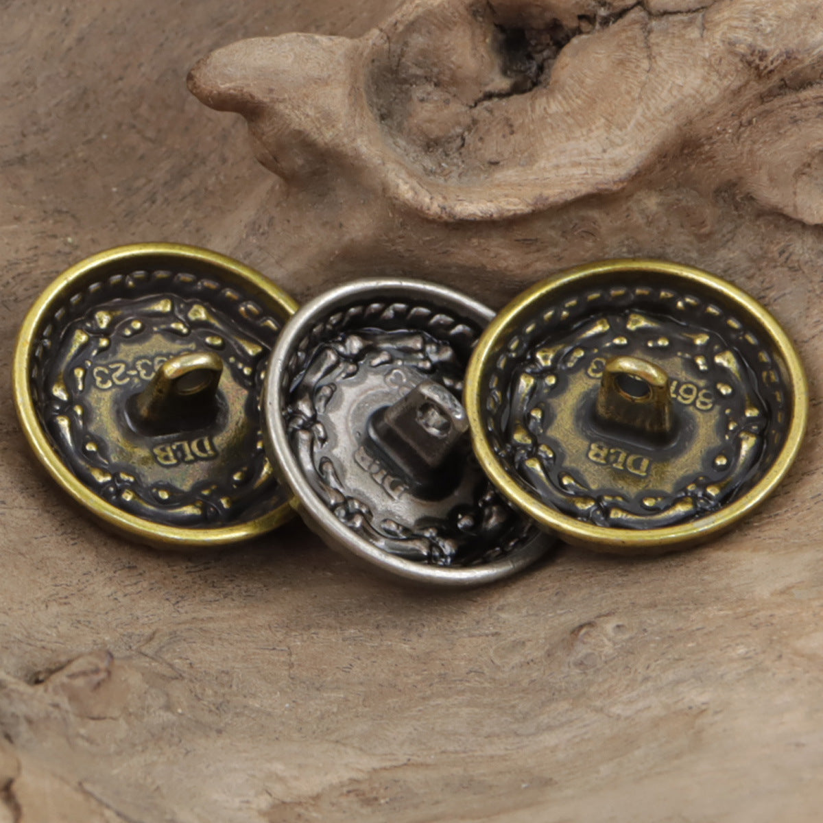 Bronze and black-silver metal buttons, round etched design with dark center