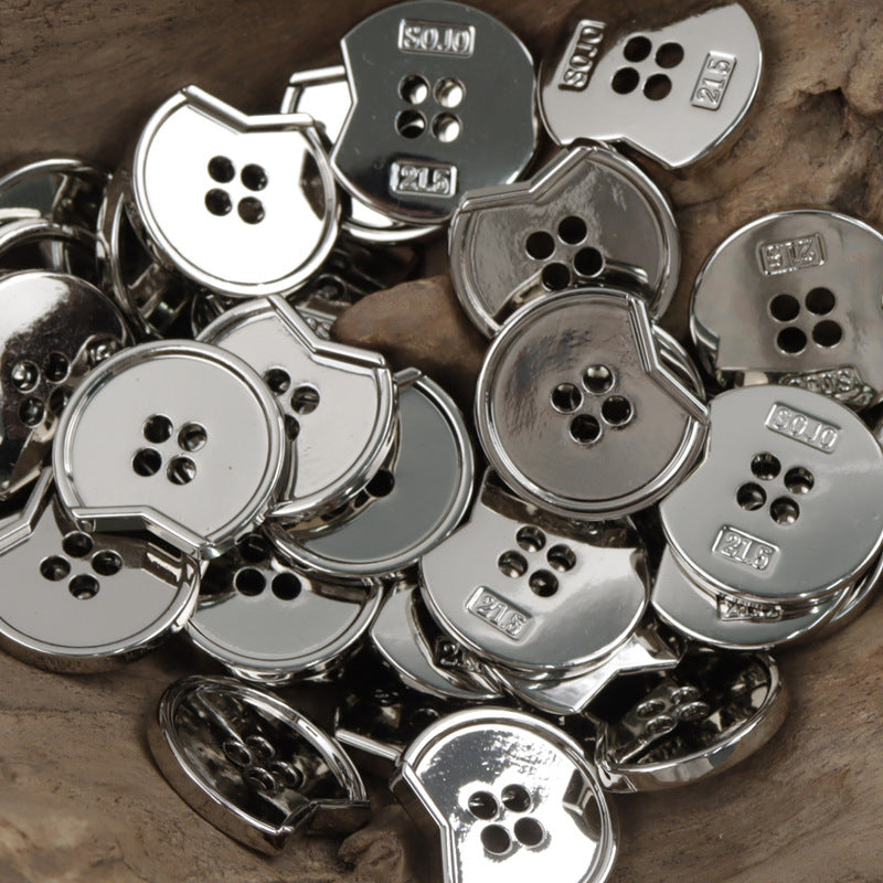 Metal 4-hole buttons, irregular notched design, close-up with silver and dark tones