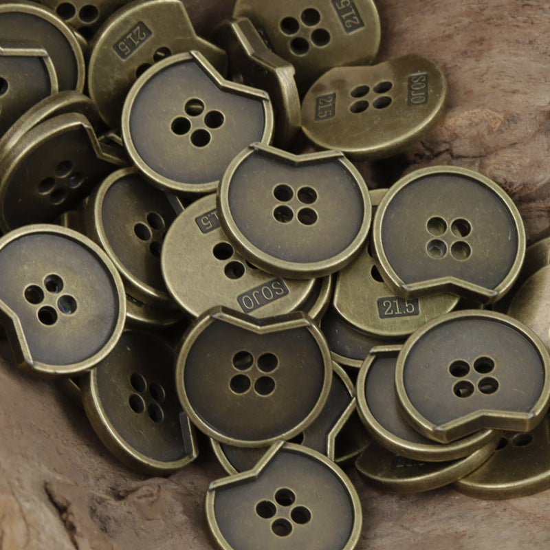 Irregular notched 4-hole metal buttons, cluster view in bronze and dark finishes