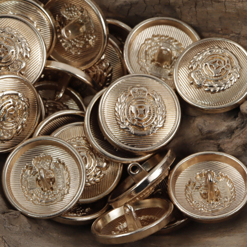 Silver wheat shield crest metal buttons with ridged texture and ornate central emblem