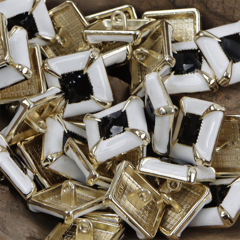 Assorted square glued metal buttons, black centers, gold-tone frames