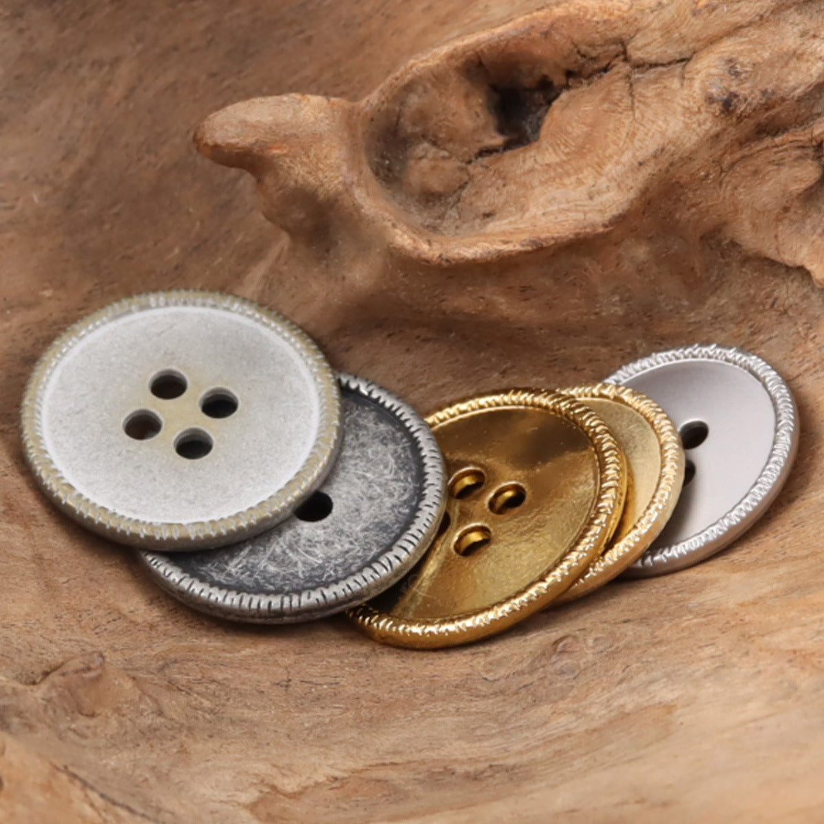 Assorted round metal buttons with 4 holes in silver, gold, and bronze tones