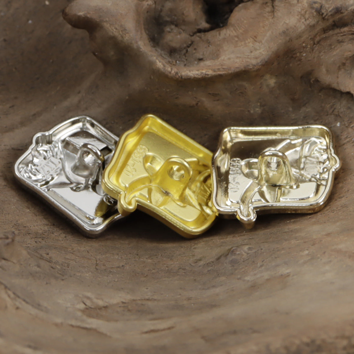 Square rose metal shank buttons in gold and silver with black center